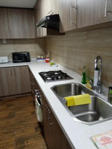 a kitchen with a sink and a stove at Departamento en playa blanca in Antofagasta