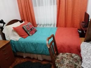 a small bed with pillows on it in a room at Departamento en playa blanca in Antofagasta