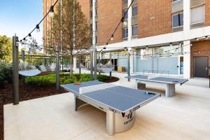 a group of ping pong tables in a courtyard at The District Skyline- 5 Points South in Birmingham