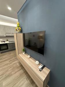 a living room with a large flat screen tv on a wall at Alloggio Nola - casa e box auto in Nola