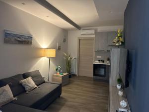 a living room with a couch and a kitchen at Alloggio Nola - casa e box auto in Nola