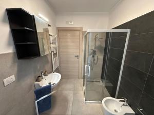a bathroom with a glass shower and a sink at Alloggio Nola - casa e box auto in Nola +12 photos