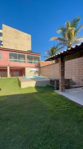 un edificio con una palmera delante en Recanto dos Monteiros, en Vila Velha