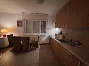 a kitchen with a table and chairs in a room at Apartman Palma in Belgrade