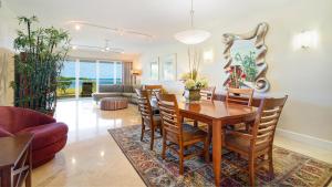 a living room with a wooden table and chairs at 523 Mariners Club in Key Largo