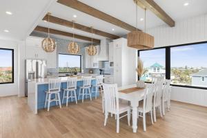 a kitchen and dining room with a table and chairs at Sunkised Sands Flagler Beach in Flagler Beach