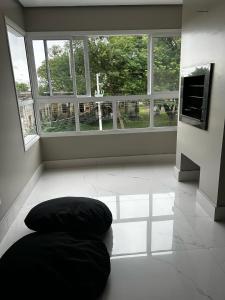 a room with a bean bag chair in front of a window at Renoir House - Apartamento Uruguaiana in Uruguaiana