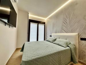 a bedroom with a bed and a window at Apartamento Flower Deluxe 6081 in Noja
