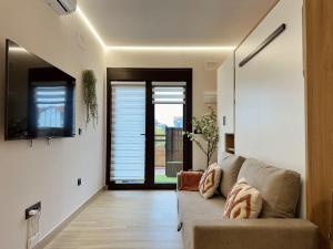a living room with a couch and a window at Apartamento Flower Deluxe 6081 in Noja