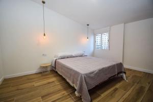 a bedroom with a bed and a wooden floor at Sweetstaybykw Moderna Casa Campo con Piscina in Asprillas +26 photos