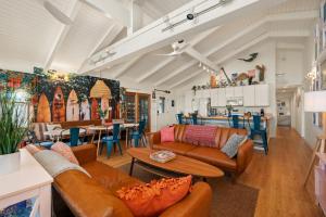 a living room with leather couches and a table at Hygge By The Sea by Rather Be Properties in Avon