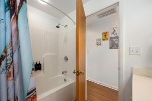 a bathroom with a shower and a white tub at Hygge By The Sea by Rather Be Properties in Avon +76 photos