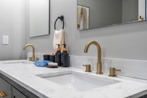 a bathroom with two sinks and two faucets at Private Room 2Bds Near Downtown in Indianapolis
