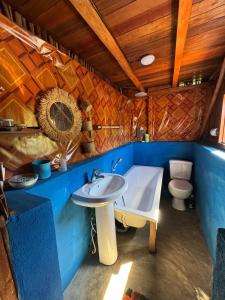 a bathroom with a sink and a toilet at Chez falisoa in Nosy Be