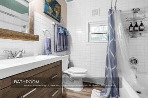 a bathroom with a toilet and a sink and a shower at Mills Cottage in Orlando