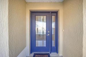 a blue door on the side of a building at Free Golf Cart & Netflix Included - 2 Mins to Brownwood Paddock-Sleeps 6 in The Villages