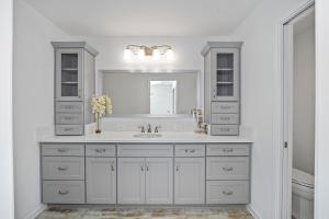 a white bathroom with a sink and a mirror at Free Golf Cart & Netflix Included - 2 Mins to Brownwood Paddock-Sleeps 6 in The Villages
