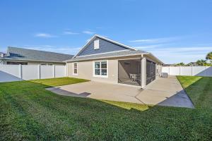 a house with a backyard with a white fence at Free Golf Cart & Netflix Included - 2 Mins to Brownwood Paddock-Sleeps 6 in The Villages