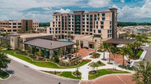 an aerial view of a resort with buildings at Free Golf Cart & Netflix Included - 2 Mins to Brownwood Paddock-Sleeps 6 in The Villages