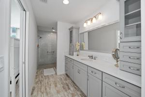 a white bathroom with a sink and a shower at Free Golf Cart & Netflix Included - 2 Mins to Brownwood Paddock-Sleeps 6 in The Villages