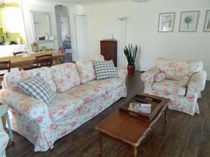 a living room with a couch and a coffee table at Cute and Cozy Lakefront Cottage in Wellington