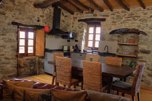 a kitchen and dining room with a table and chairs at Casal do Amor in Lousã