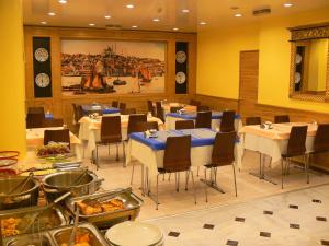 a dining room with tables and chairs with food at Hotel Inter Istanbul in Istanbul