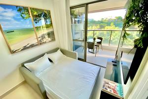 a bedroom with a bed and a view of the ocean at Capitães de Areia in Salvador