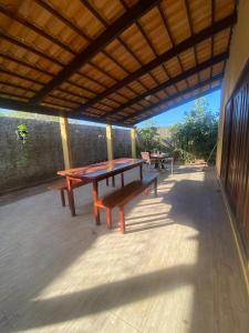 a patio with a table and benches on it at Casa do Sol in Tibau do Sul +7 photos