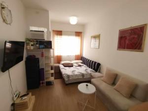a living room with a couch and a table at Sunbeams Studio Unit in Lapu Lapu City