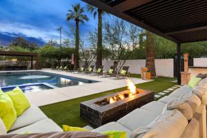 a patio with a fire pit next to a pool at Arcadia Beach Club - 4-Villa Luxe Retreat with Pool in Phoenix