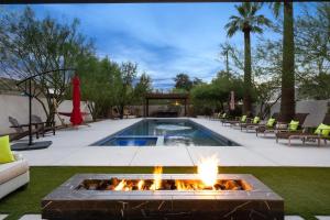 a backyard with a pool with a fire pit at Arcadia Beach Club - 4-Villa Luxe Retreat with Pool in Phoenix