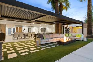 an outdoor patio with a couch and a fire pit at Arcadia Beach Club - 4-Villa Luxe Retreat with Pool in Phoenix