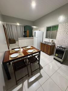 a kitchen with a table and a kitchen with a refrigerator at Spacious and comfortable apartment in Oiapoque +13 photos