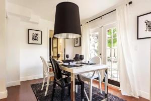 a dining room with a white table and chairs at 4BD 2BA - Black&White ArtBNB - Antique Row WPB in West Palm Beach