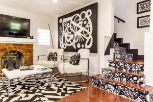 a living room with two chairs and a fireplace at 4BD 2BA - Black&White ArtBNB - Antique Row WPB in West Palm Beach +25 photos