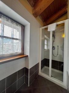 a bathroom with a shower with a glass door at 1Dest - Sweet Spot in Riva del Garda +36 photos