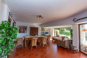 a living room with a table and chairs at Finca Tolombreo Casa Gabriel in Cudillero
