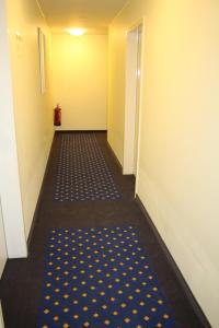 an empty hallway with a blue and yellow carpet at ITM Hotel an der Bille in Hamburg