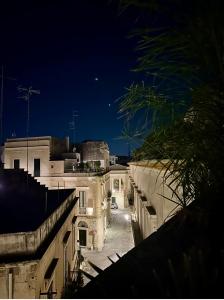 a view of an alley at night from a building at Sottolavolta in Lecce