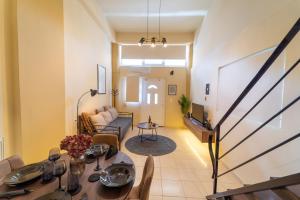 a living room with a table and a couch at Sunset Loft Crete in Thérissos