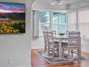 a dining room with a table and chairs and a window at Quaint Mid-Century Cottage by the Coast in Ventura