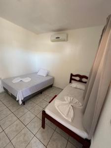 a bedroom with two beds in a room at Pousada Brisa do Mar in Galinhos