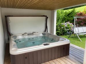 a jacuzzi tub sitting on a deck at Location Eyheraldia votre Triplex au cœur du Pays Basque in Hasparren