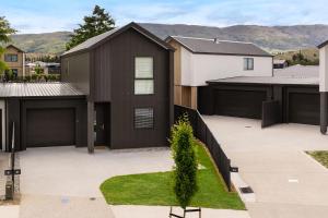a house with a black garage at Stirling Woods Retreat in Cromwell