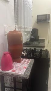 イタニャエンにあるcasa 3, espaço inteiroのキッチン(コンロ、テーブル、カップ付)