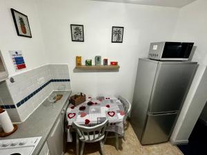 a small kitchen with a table and a refrigerator at CustomerHouse Dublin 1, Balcony View in Dublin +8 photos