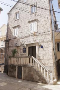 a stone building with a staircase in front of it at Apartment Biline Center in Korčula +13 photos