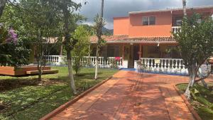 a house with a pathway in front of it at Villa El Rio in Cali