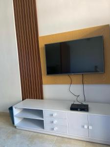 a white entertainment center with a tv on a wall at Agora Sidi Abdelrahman - One Bedroom Chalet in El Alamein